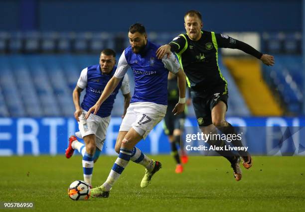 Atdhe Nuhiu of Sheffield Wednesday beats Danny Grainger of Carlisle United during the Emirates FA Cup Third Round Replay match between Sheffield...