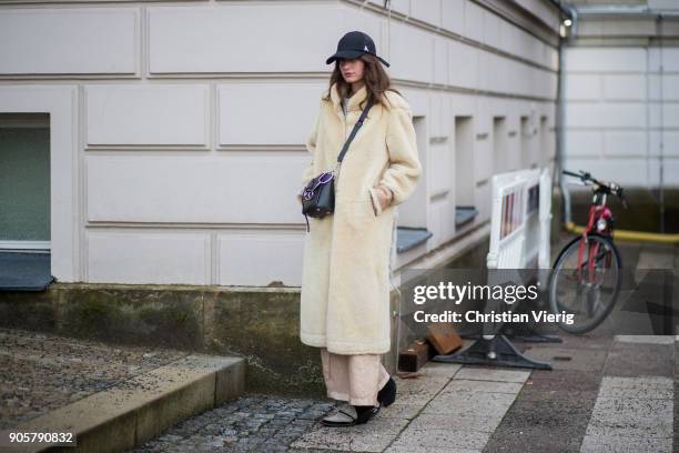 Guest wearing teddy coat, cap is seen outside Der Berliner Modesalon during the Berlin Fashion Week January 2018 on January 16, 2018 in Berlin,...