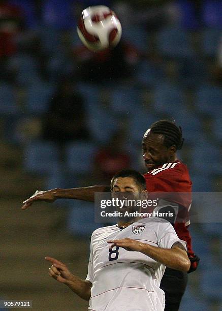 Dennis Lawrence of Trinidad Tobago fights for the ball with Clint Dempsey of United States during their FIFA 2010 World Cup qualifier at the Hasely...