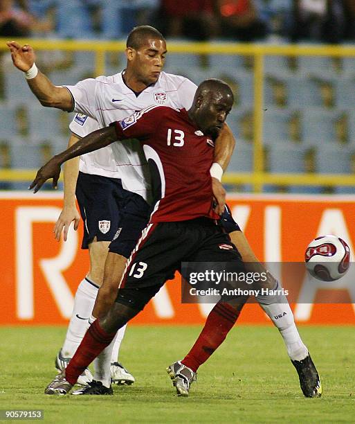 Cornell Glen of Trinidad Tobago fights for the ball with Oguchi Onyewu of United States during their FIFA 2010 World Cup qualifier at the Hasely...