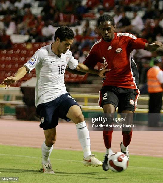 Keon Daniel of Trinidad Tobago fights for the ball with Benny Feilhaber of United States during their FIFA 2010 World Cup qualifier at the Hasely...