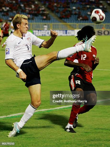 Keon Daniel of Trinidad Tobago fights for the ball with Stuart Holder of United States during their FIFA 2010 World Cup qualifier at the Hasely...