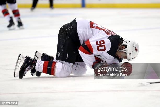 Marcus Johansson of the New Jersey Devils slumps to the ice in the second period after getting injured against the New York Islanders during their...