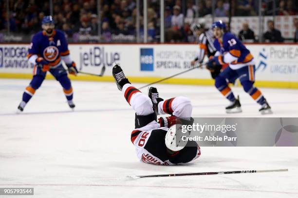Marcus Johansson of the New Jersey Devils lies on the ice in the second period after being injured against the New York Islanders at Barclays Center...