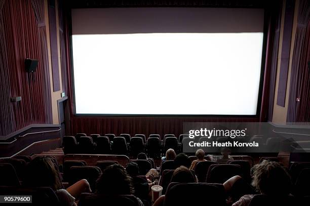 audience at movie theater. - cinema interior stock pictures, royalty-free photos & images
