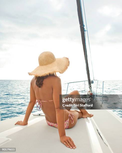 woman relaxing on bow of sailboat - siri stafford stock pictures, royalty-free photos & images