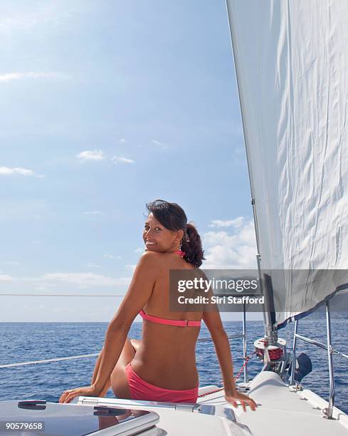 young woman on bow of sailboat, smiling - siri stafford stock pictures, royalty-free photos & images