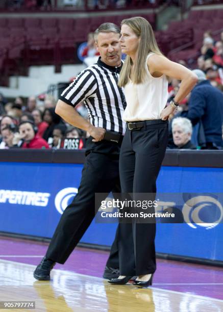 Official Tim Daley shows head coach Kim Barnes Arico of the Michigan Wolverines why he called a foul during the game between the Ohio State Buckeyes...