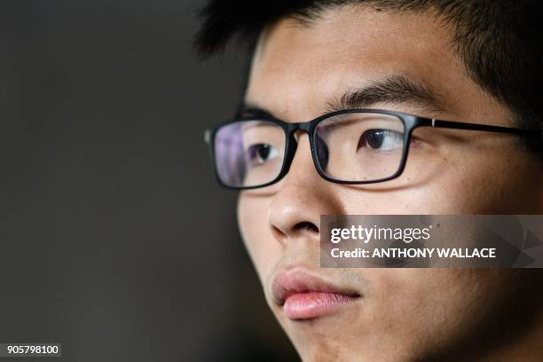 Pro-democracy activist Joshua Wong prepares to enter the High Court to hear his sentence on a protest related charge in Hong Kong on January 17,...