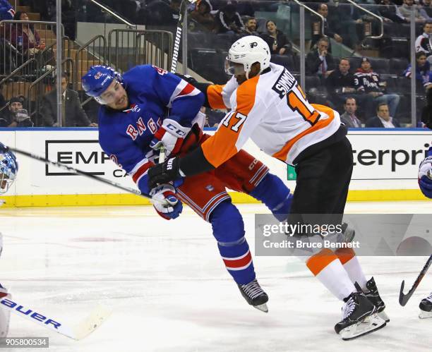 Wayne Simmonds of the Philadelphia Flyers checks Brendan Smith of the New York Rangers during the third period at Madison Square Garden on January...