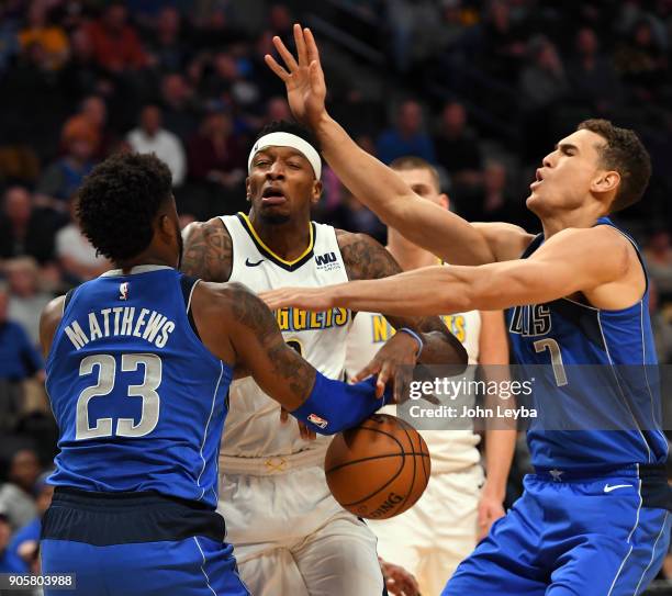 Denver Nuggets guard Torrey Craig loses control of the ball between Dallas Mavericks guard Wesley Matthews and forward Dwight Powell during the first...