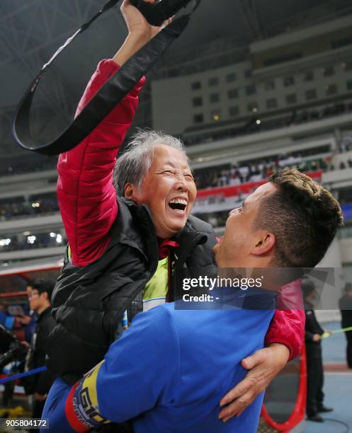 This photo taken on November 26, 2017 shows Shanghai Shenhua's Giovanni Moreno lifting up photographer Hong Nanli after the Chinese FA football match...