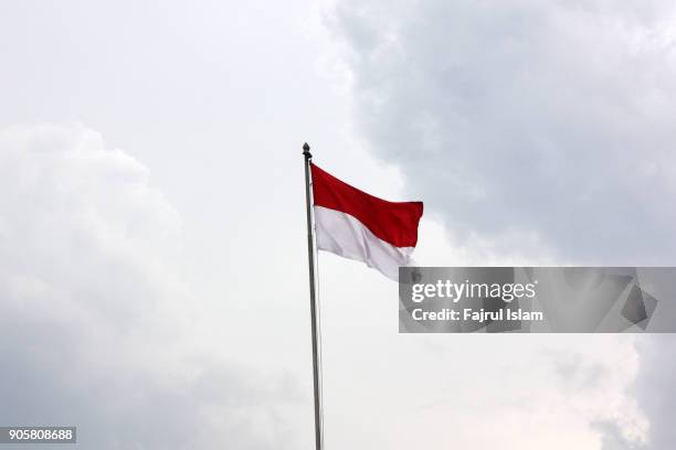 indonesian flag with sky as background - indonesia flag stock pictures, royalty-free photos & images