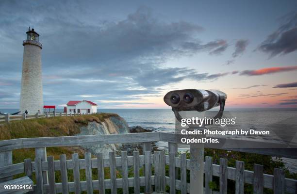 view finder at cap des rosiers lighthouse during sunset - coin operated binocular nobody stock pictures, royalty-free photos & images