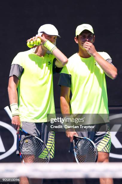 Marc Polmans of Australia and Andrew Whittington of Australia talk tactics in their first round men's doubles match against Juan Sebastian Cabal of...