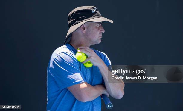 Former player turned coach Andre Agassi watches Novak Djokovic practice in the heat on day three of the 2018 Australian Open at Melbourne Park on...