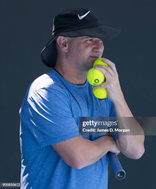 Former player turned coach Andre Agassi watches Novak Djokovic practice in the heat on day three of the 2018 Australian Open at Melbourne Park on...