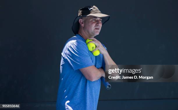 Former player turned coach Andre Agassi watches Novak Djokovic practice in the heat on day three of the 2018 Australian Open at Melbourne Park on...