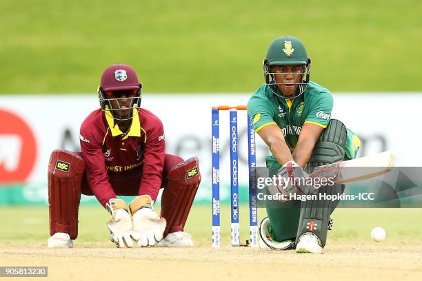 Kenan Smith of South Africa bats while captain Emmanuel Stewart of the West Indies looks on during the ICC U19 Cricket World Cup match between the...