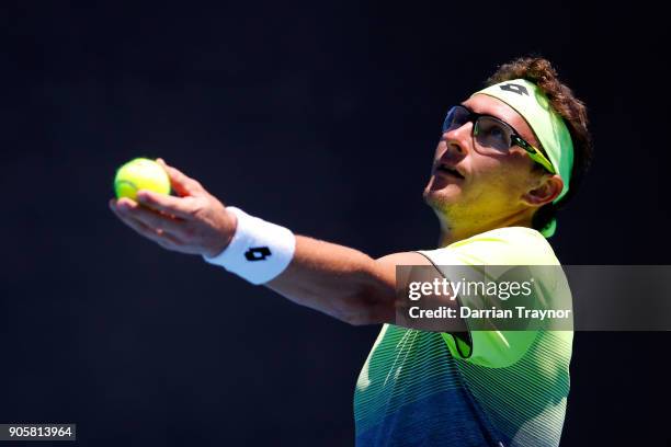 Denis Istomin of Uzbekistan serves in his second round match against Kyle Edmund of Great Britain on day three of the 2018 Australian Open at...