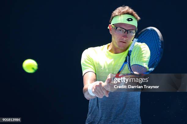 Denis Istomin of Uzbekistan plays a backhand in his second round match against Kyle Edmund of Great Britain on day three of the 2018 Australian Open...