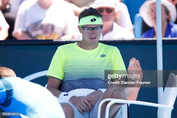 Denis Istomin of Uzbekistan attempts to cool down in his second round match against Kyle Edmund of Great Britain on day three of the 2018 Australian...