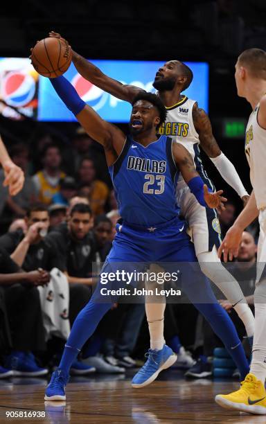 Denver Nuggets guard Will Barton knocks the ball away from Dallas Mavericks guard Wesley Matthews during the first quarter on January 16, 2018 at...