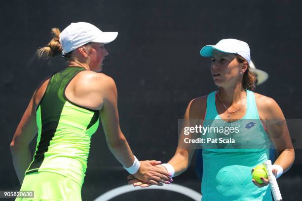 Oksana Kalashnikova of Georgia and Varvara Lepchenko of the United States talk tactics in their first round doubles match with against Qiang Wang of...