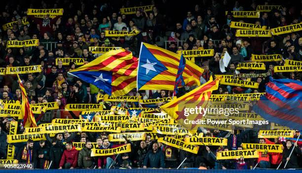 Supporters of FC Barcelona wave the Catalan pro-independence "Estelada" and "Llibertat" flags during the Copa Del Rey 2017-18 Round of 16 match...