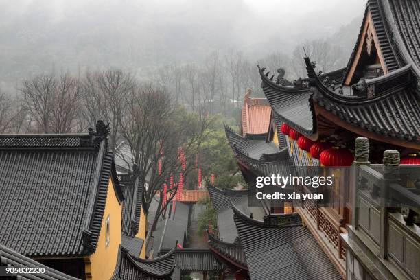 rooftop view of temple against misty mountains,hangzhou,china - hangzhou bildbanksfoton och bilder