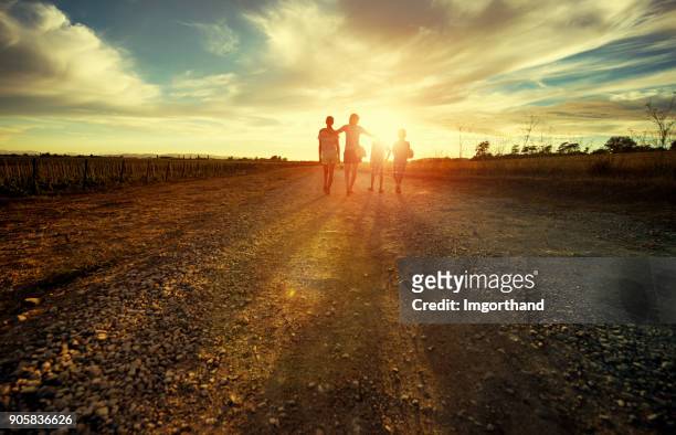 mother with kids walking on country road - four people stock pictures, royalty-free photos & images
