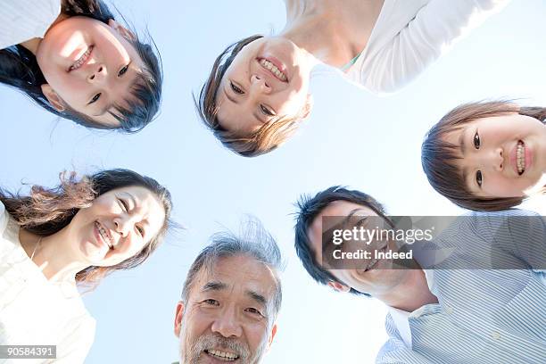 multi-generation family smiling, directly below - kid looking up to the sky imagens e fotografias de stock