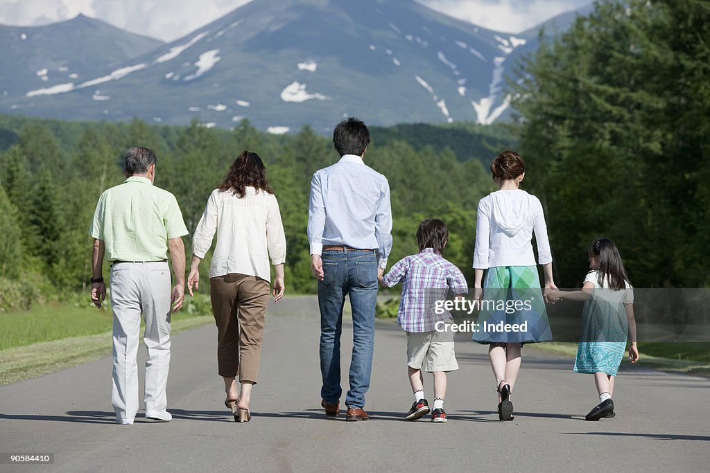 Multi-generational family walking on road