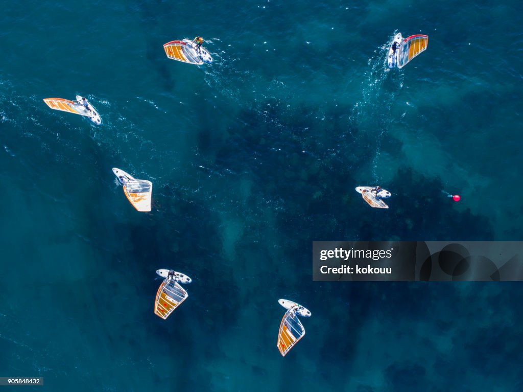 A lot of yachts floating on the horizon and the sea.