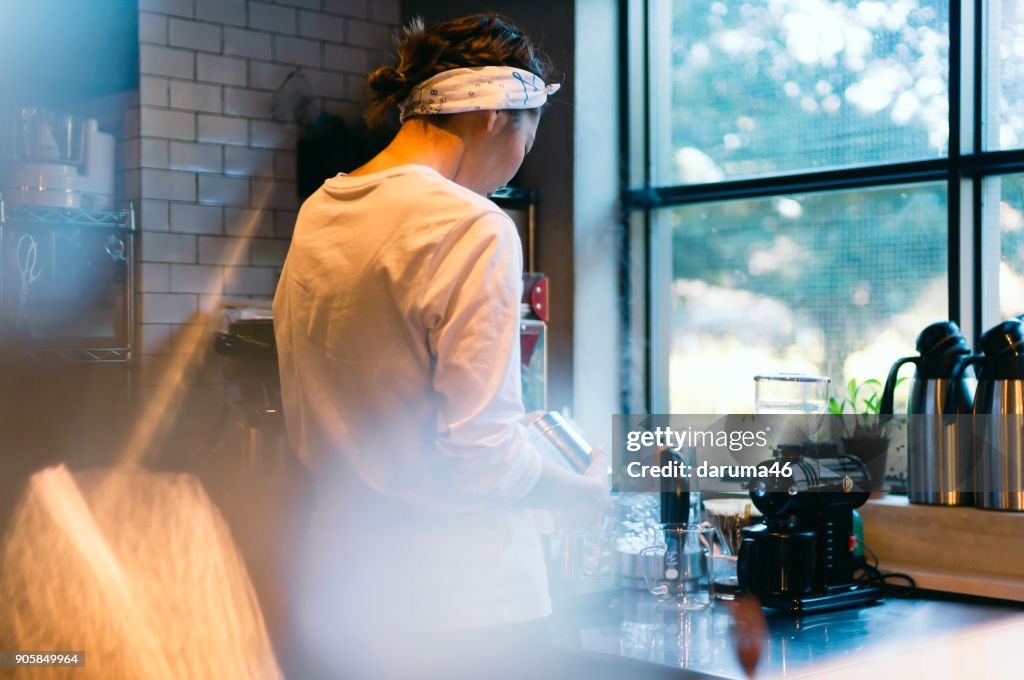 Rear View of Barista Making Coffee Machine at Cafe Counter