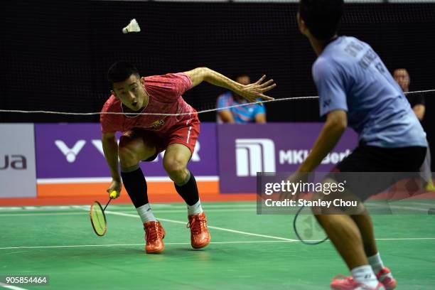 Chen Long of China plays a return shot to Anthony Sinisuka Ginting of Indonesia during the Men Singles round one match of the Perodua Malaysia...