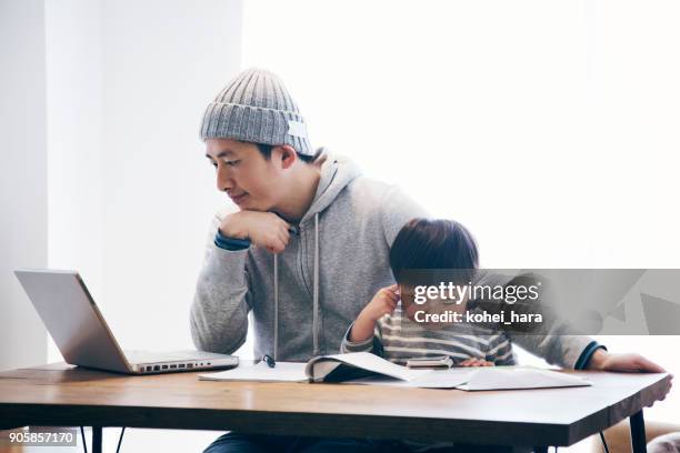 father with son working at home - financial wellbeing stock pictures, royalty-free photos & images