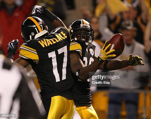 Wide receiver Santonio Holmes of the Pittsburgh Steelers celebrates his touchdown in the second quarter with teammate Mike Wallace during the NFL...