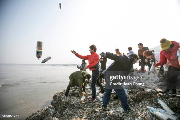Activists throw PET bottles on an island near the DMZ on January 17, 2018 in Incheon, South Korea. The human rights group organised by North Korean...