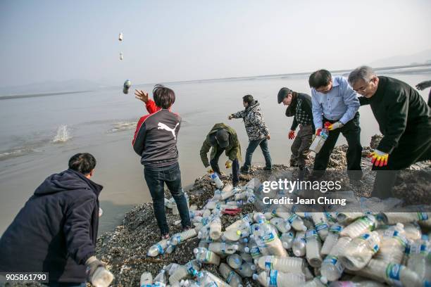 Activists throw PET bottles on an island near the DMZ on January 17, 2018 in Incheon, South Korea. The human rights group organised by North Korean...