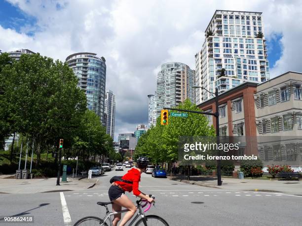 young cyclist on city streets - traffic light control box stock pictures, royalty-free photos & images