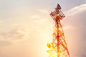 Abstract telecommunication tower Antenna and satellite dish at sunset sky background