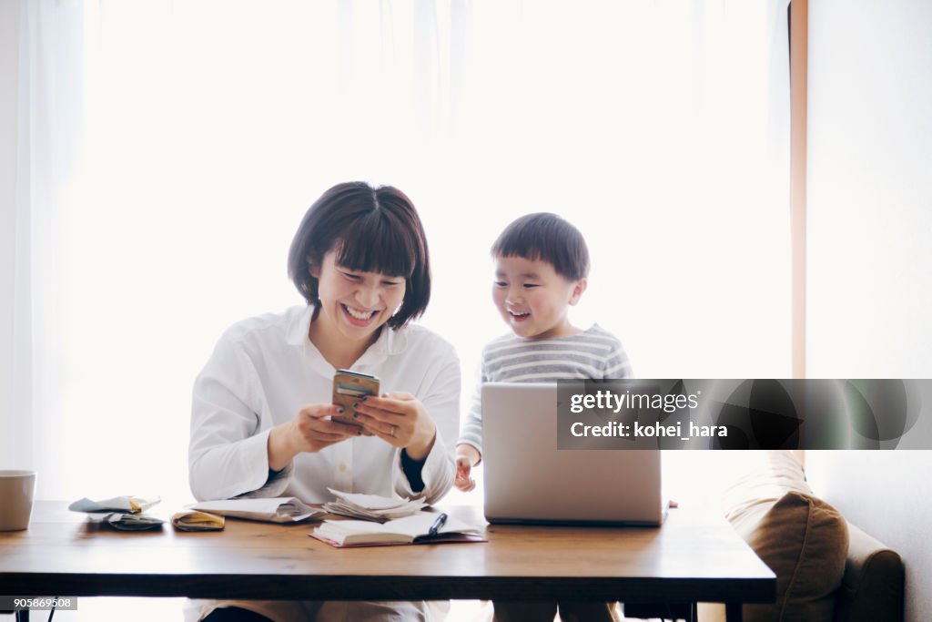 Mother with son working at home