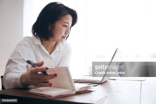 woman working at home - agenda diary stock pictures, royalty-free photos & images