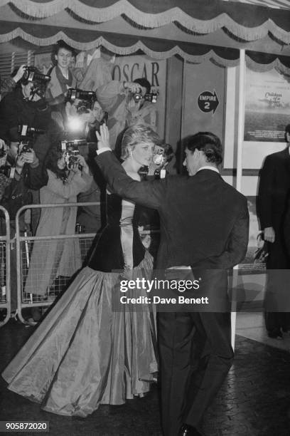 Diana, Princess of Wales, wearing off-the-shoulder flamenco style dress, and Charles, Prince of Wales, at the UK premiere of the film 'Children Of A...