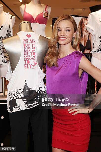 Victoria's Secret Angel Miranda Kerr poses with the t-shirt she created at the Victoria's Secret Supermodels celebration of Fashion's Night Out at...