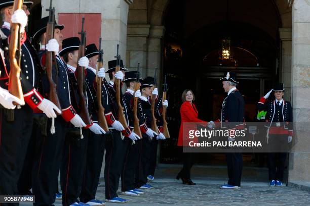 Members of the Catalan regional police force Mossos d'Esquadra salute former president of Catalan parliament Carme Forcadell before Catalan's...