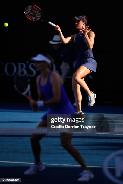 Andrea Petkovic of Germany returns serve in her first round doubles match with Mirjana Lucic-Baroni of Croatia against Monica Niculescu of Romania...