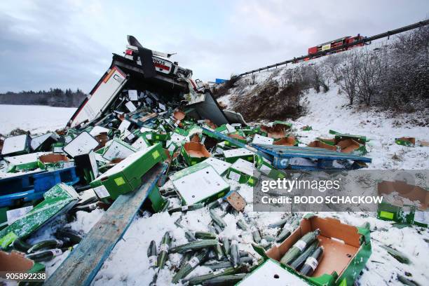 Cucumbers lay in the snow after a truck that was loaded with the cargo slipped off the snow packed A 9 highway near Schleiz, eastern Germany, on...