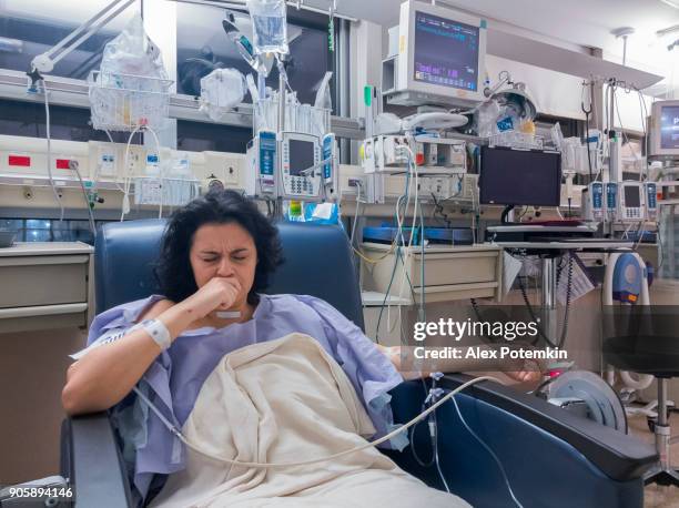 attractive mature post-op woman sedated after a surgery resting in a hospital - caucasian woman sick in bed coughing stock pictures, royalty-free photos & images